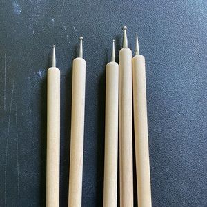 Wood grip but metal pieces at the end. Only used a couple times. Great condition